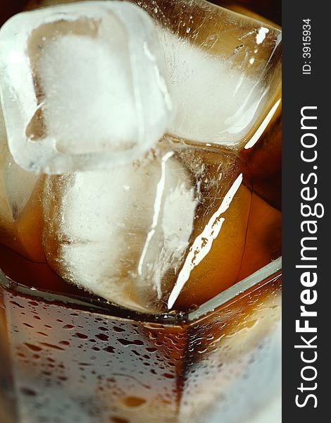 Ice cubes soaked in cold whisky drink