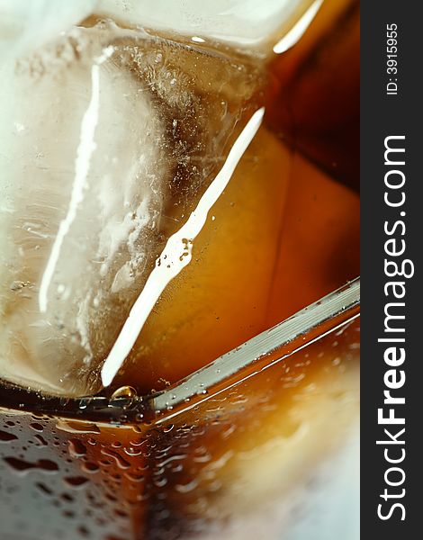 Ice cubes soaked in cold whisky drink