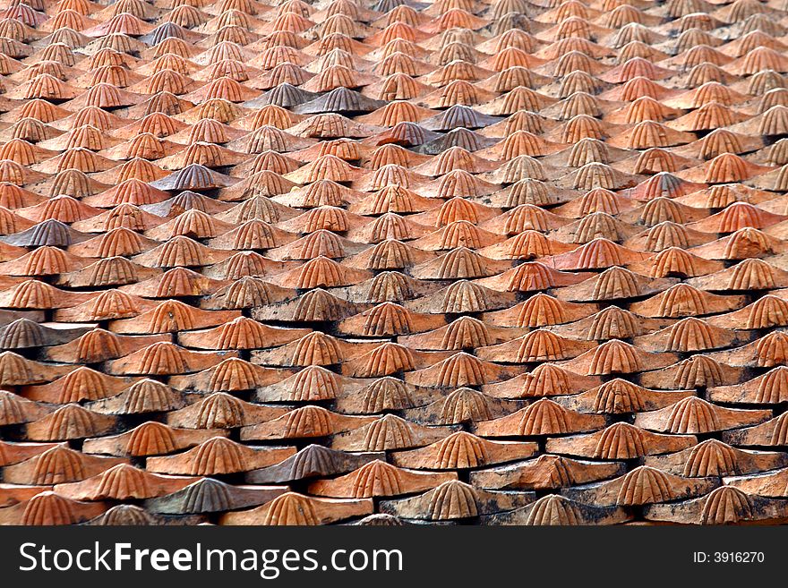 A roof with a lot of red plane tiles