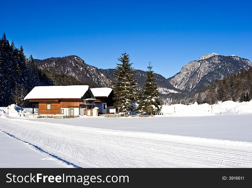 An alpine scene with chalets in a ski resort