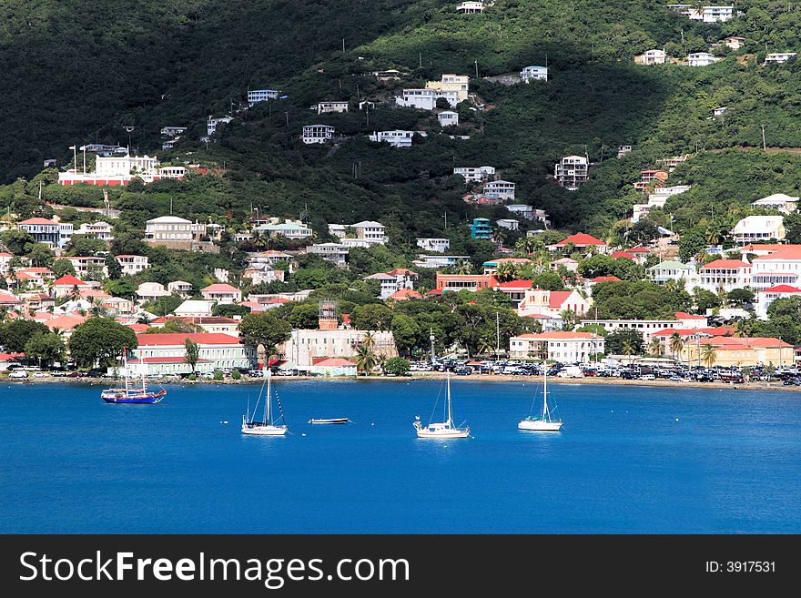 Tropical houses on hill overlooking harbor. St John US Virgin Islands