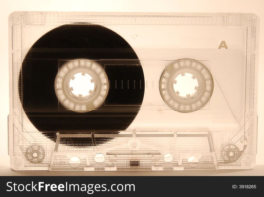 Tape in transparent plastic cassette on white background. Tape in transparent plastic cassette on white background