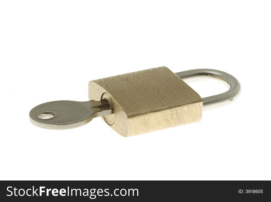 Isolated closed brass padlock with key inside