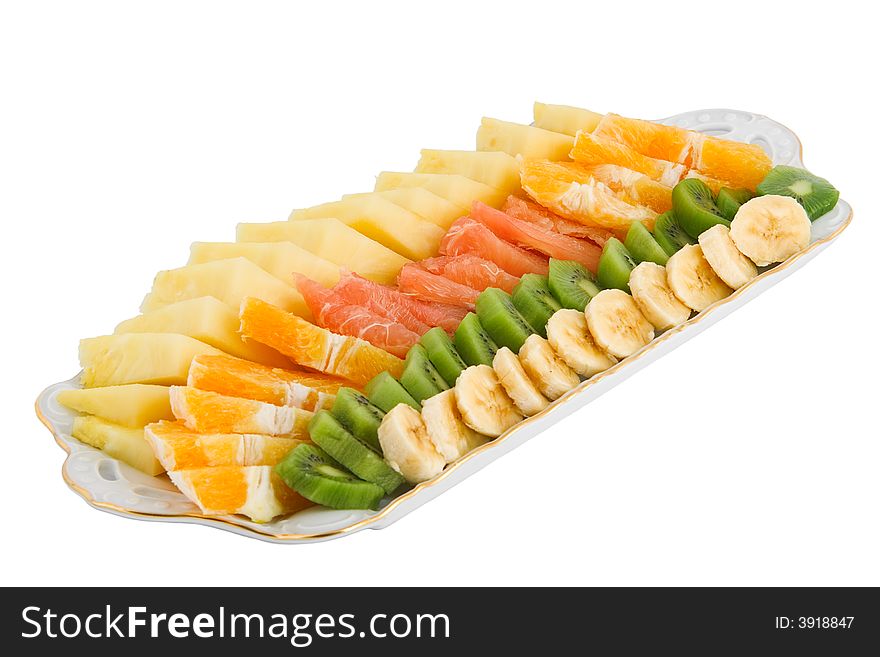 Fruit salad made of banana, kiwi, orange, grapefruit and pineapple isolated on white