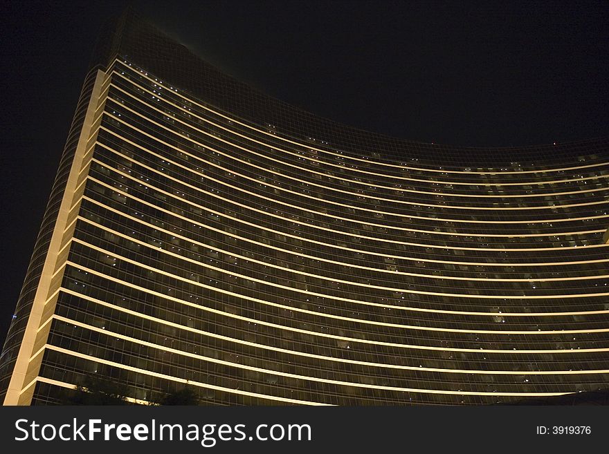 A curved black and white hotel shot at night. A curved black and white hotel shot at night