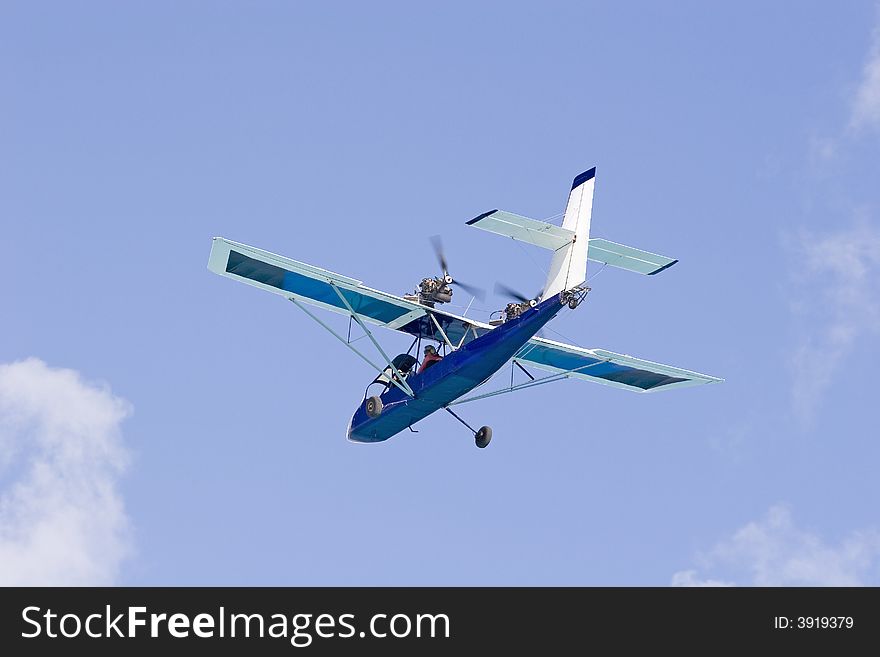 A small rear prop plane flying against the sky