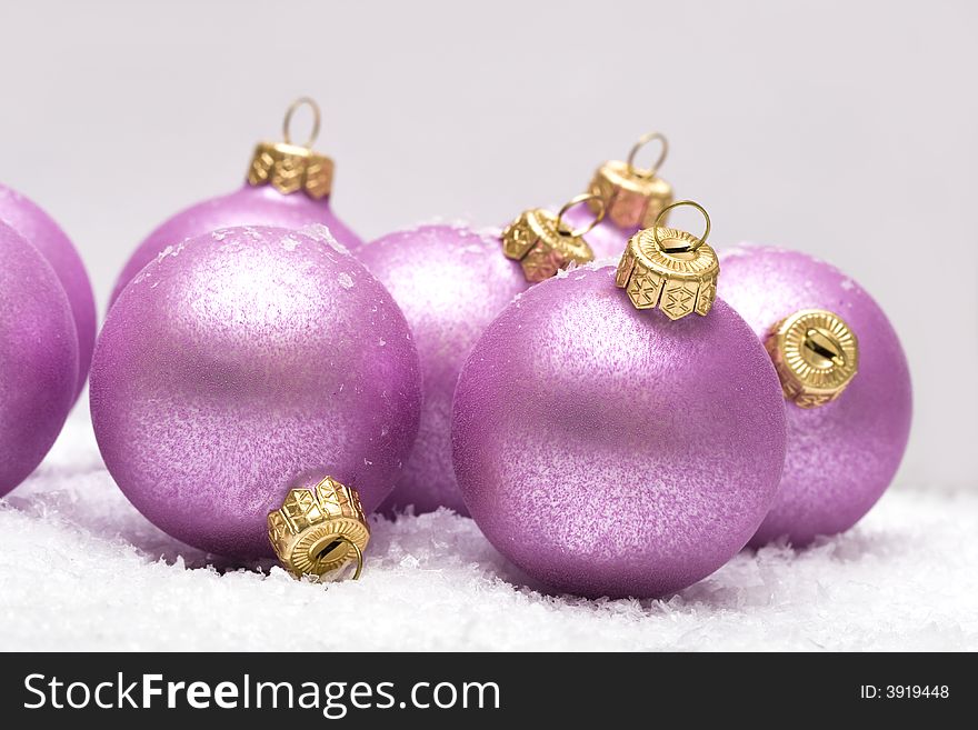 Pink Christmas balls in snow
