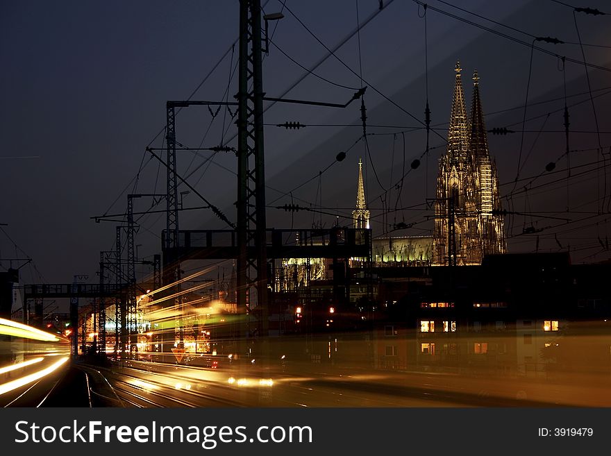 Cologne city by night with the cologne cathedral. in front trains comming from central station