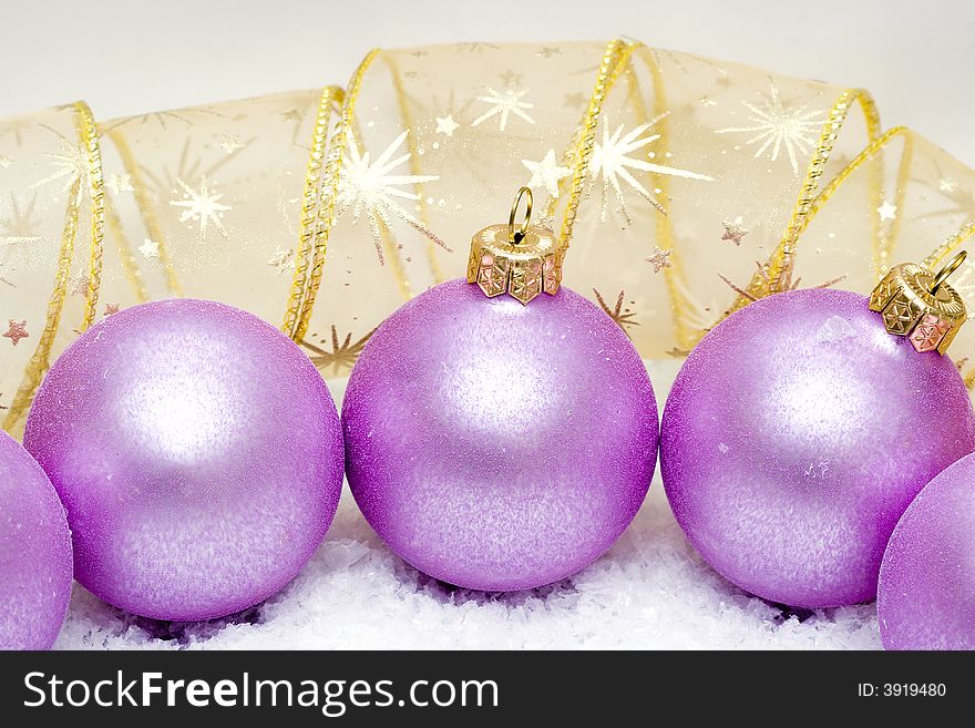 Pink Christmas balls in snow