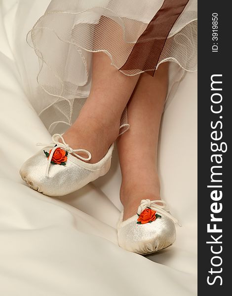 Shoes of a young flower girl at a wedding. Shoes of a young flower girl at a wedding