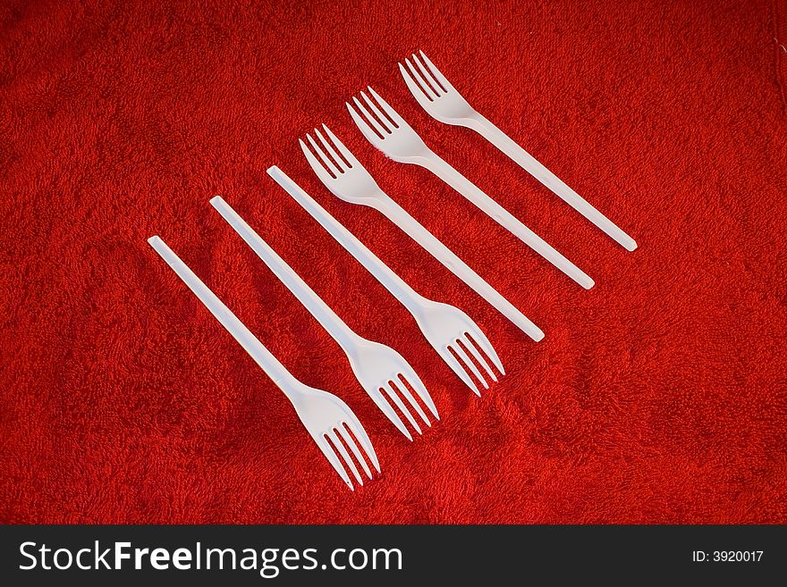 Plastic Forks On Red Background