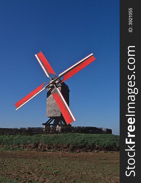 Working old windmill in Belgium, front vieuw in middle of field. Working old windmill in Belgium, front vieuw in middle of field