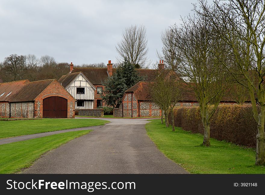 Timber Framed Country House and Brick and Flint Outbuildings in Rural Estate in England. Timber Framed Country House and Brick and Flint Outbuildings in Rural Estate in England