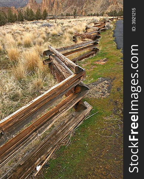 Crooked log fence extending into the distance