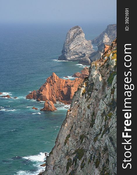 Aqua ocean in portugal with rocky cliffs. Aqua ocean in portugal with rocky cliffs