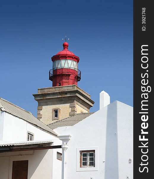 Red lighthouse with white buliding on clear blue sky. Red lighthouse with white buliding on clear blue sky