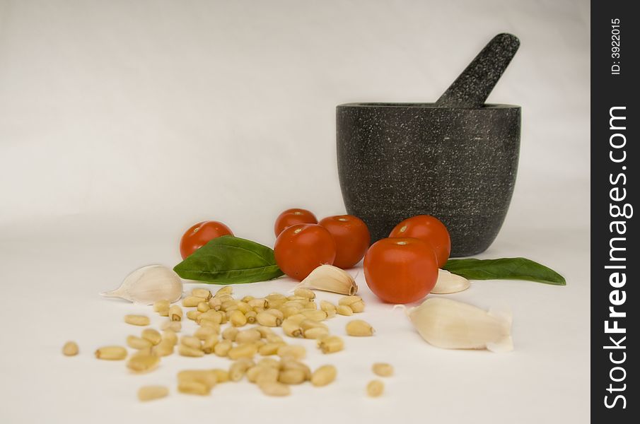 Italian Cooking Ingredients. Basil, pinenuts, garlic, and mortar