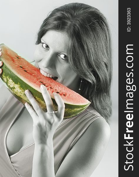 A woman eating a watermelon. A woman eating a watermelon