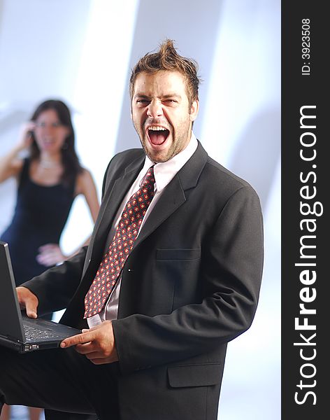 Shouting man in an office with notebook