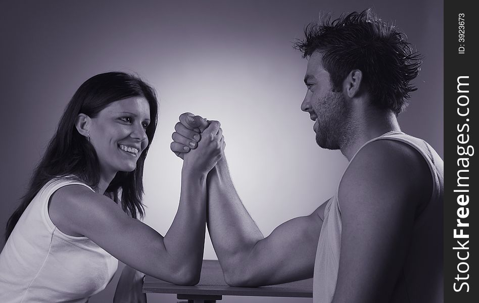 A pair plays game arm wrestling.