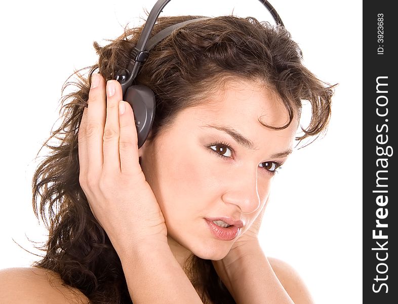 Beautiful young girl listening a music on a headphones
