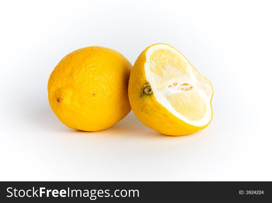 A lemon and a half isolated on white background