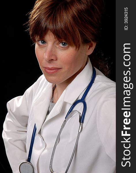 Cute young lady doctor with stethoscope, on black. Cute young lady doctor with stethoscope, on black