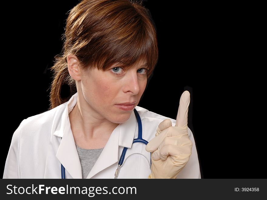 Cute young lady doctor with latex gloves, on black