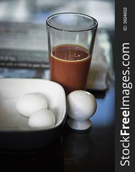 Photograph of a hard boiled eggs breakfast with tomato juice. Photograph of a hard boiled eggs breakfast with tomato juice.