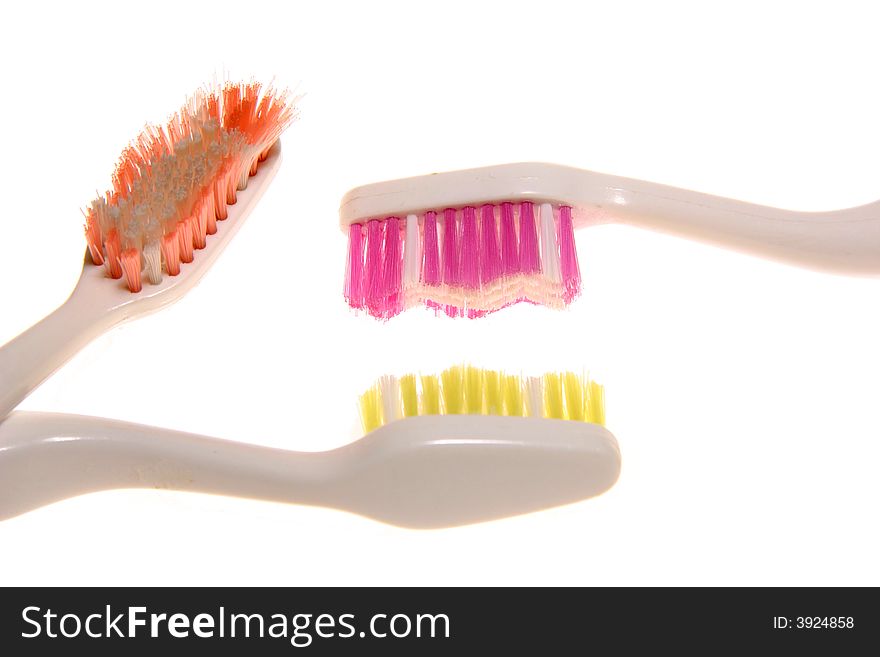 Three toothbrushes of different colors