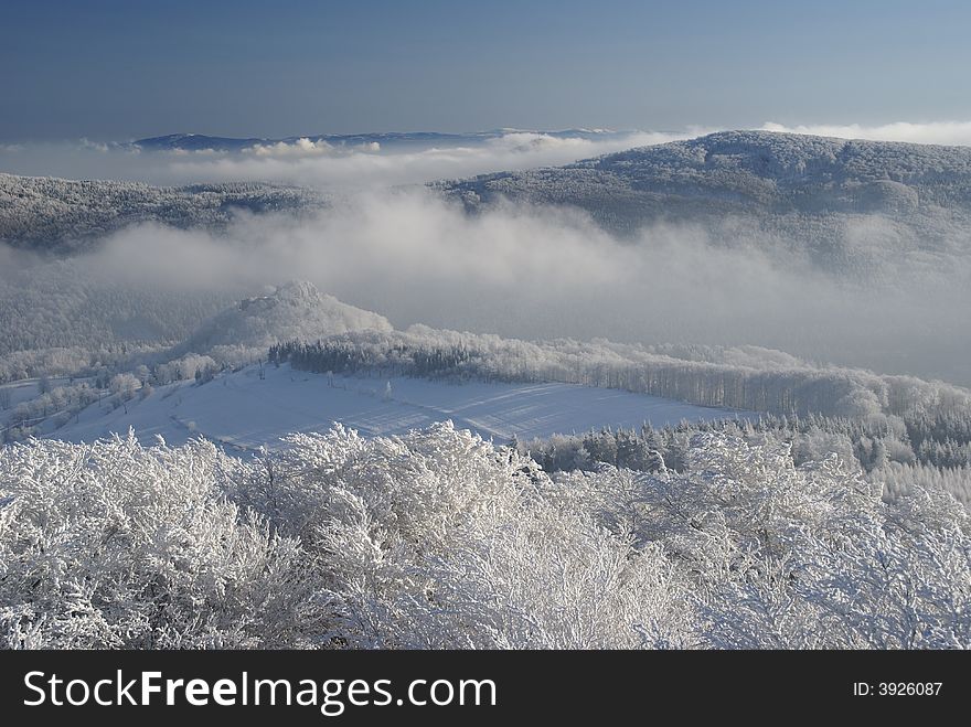 Winter inversion and low lying clouds in snow covered hilly country. Winter inversion and low lying clouds in snow covered hilly country.