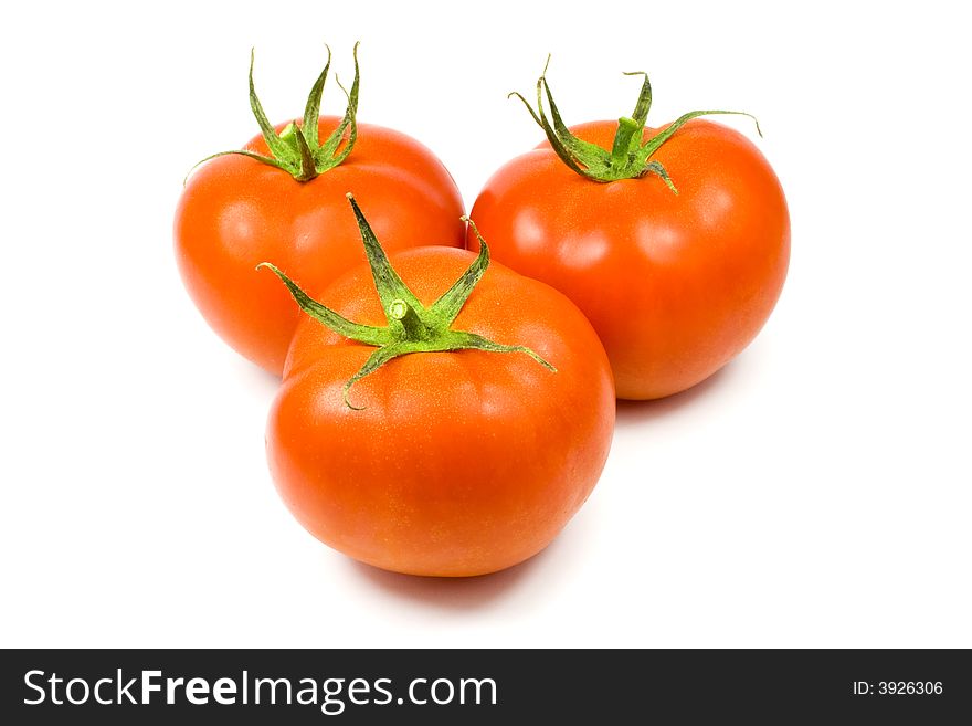 Three full tomatoes isolated on white background