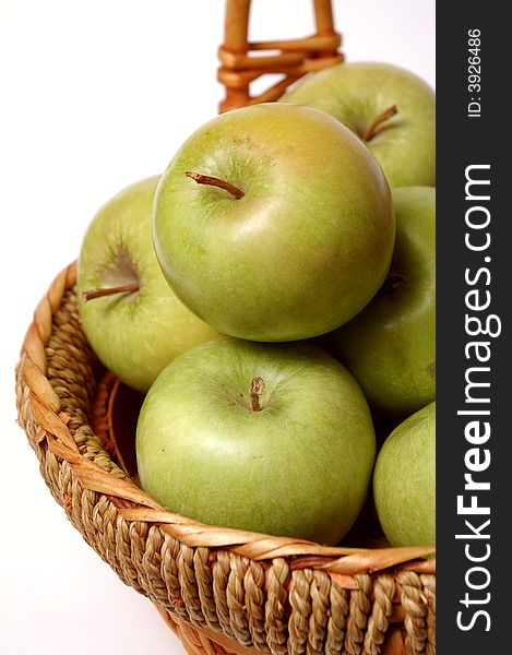 Basket with apples on a bel a background
