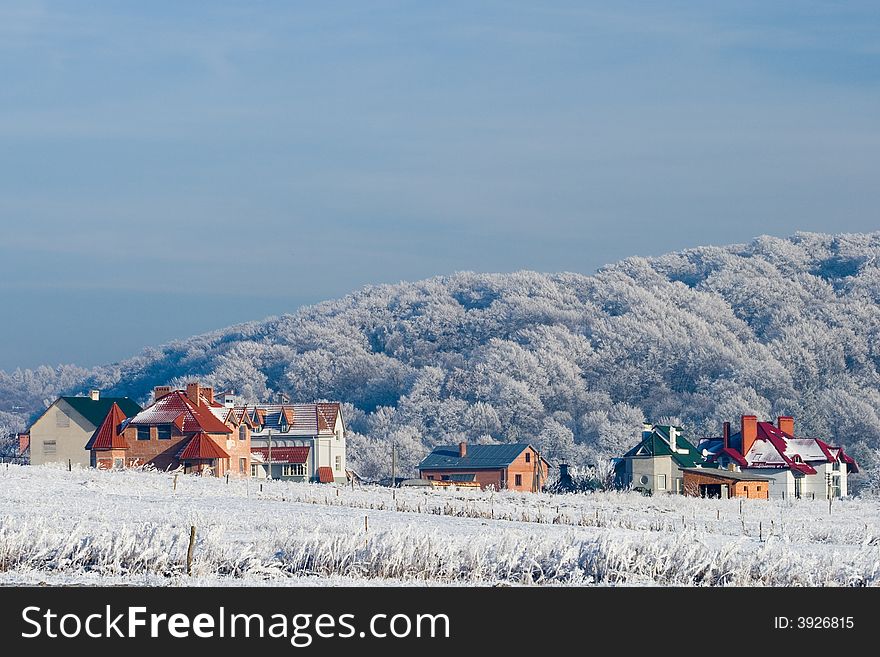 Winter landscape: frozen trees over blue sky