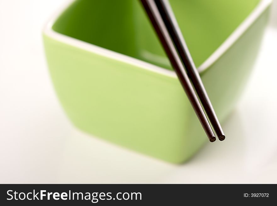 Chopsticks & Green Bowl on a white background.