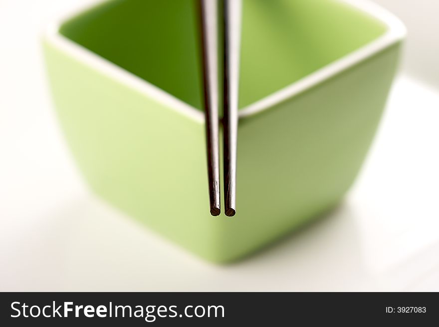 Chopsticks & Green Bowl on a white background.