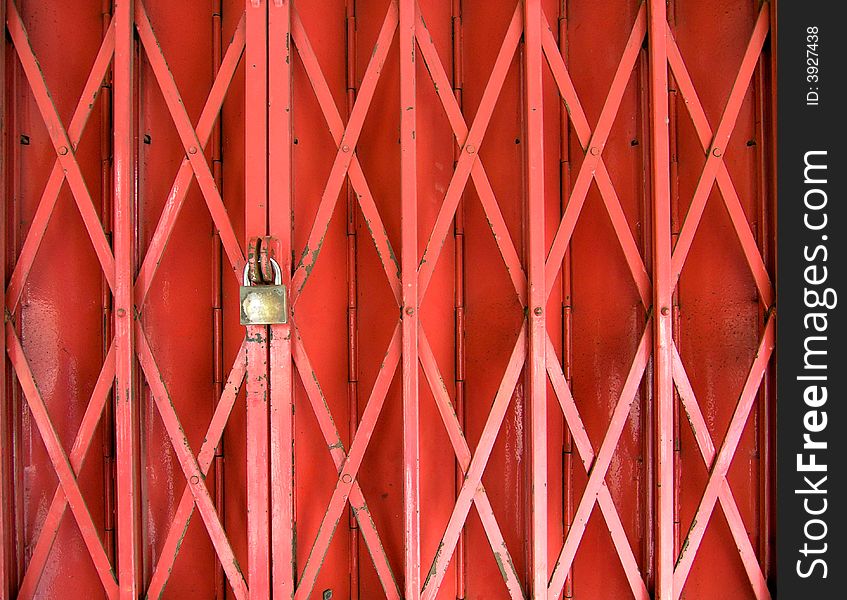 A collapsible gate locked before a collapsible panel door. A collapsible gate locked before a collapsible panel door