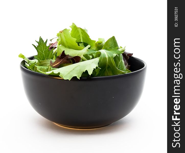 A closeup of a bowl of salad greens.