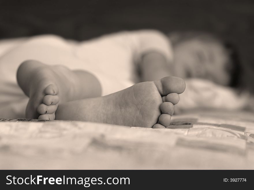 Portrait of little girl sleeping with focus on feet