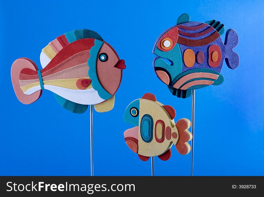 Three family fishes on blue background