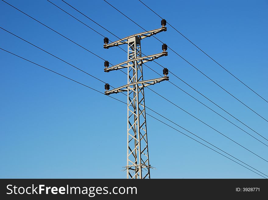 Electrical tower on a background of the blue sky. Electrical tower on a background of the blue sky