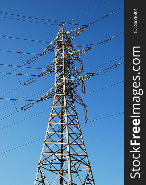 Electrical tower on a background of the blue sky. Electrical tower on a background of the blue sky