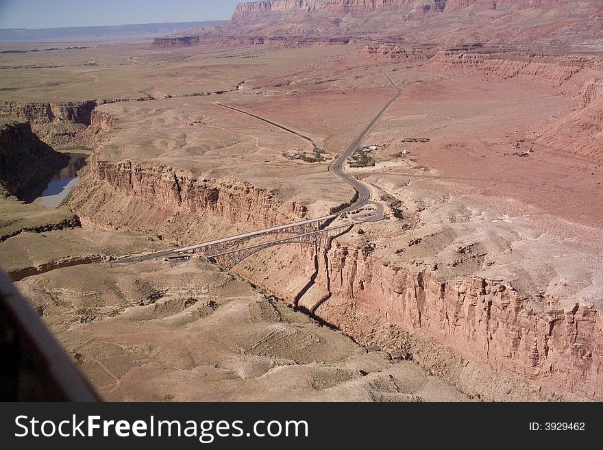 Looking south at the Navajo Bridge (bridges) over the Colorado River in Marble Canyon, Arizona. Looking south at the Navajo Bridge (bridges) over the Colorado River in Marble Canyon, Arizona.