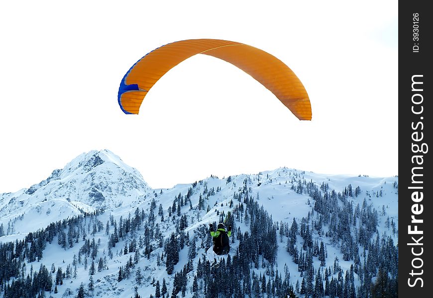 Paraglider with snowy mountain in the background.