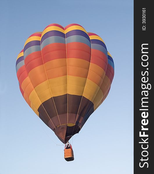 Colourful hot-air balloon on a blue sky background