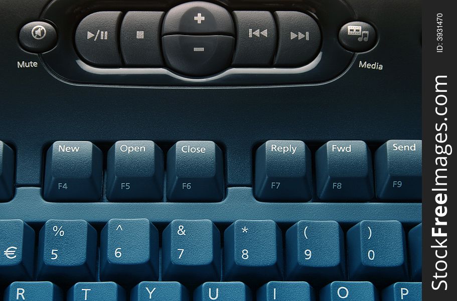 Close-up of media computer keyboard overlaid with blue. Close-up of media computer keyboard overlaid with blue