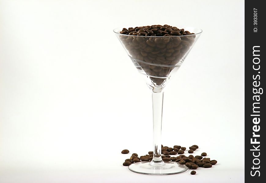 Martini glass full of coffee beans right offset. Martini glass full of coffee beans right offset.