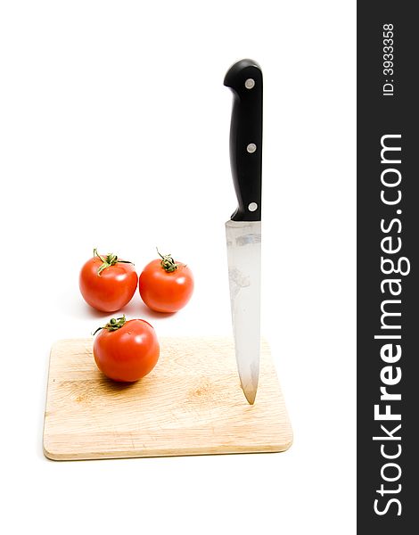 Three red tomato on kitchen board. Three red tomato on kitchen board