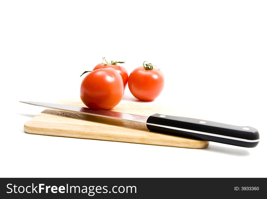 Three red tomato on kitchen board. Three red tomato on kitchen board