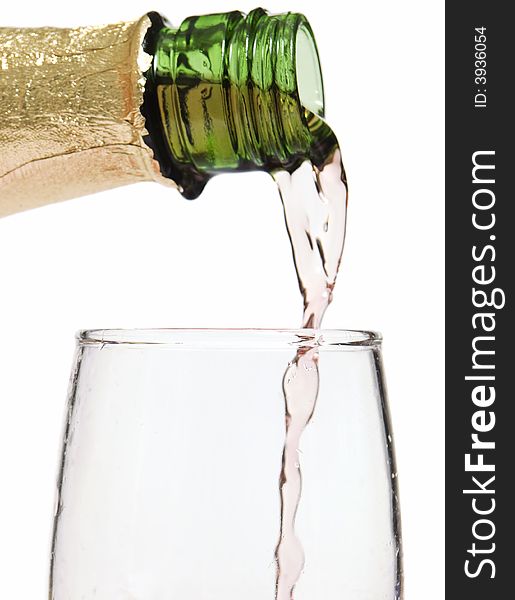 Glass of wine / champagne being poured with a white background. Glass of wine / champagne being poured with a white background
